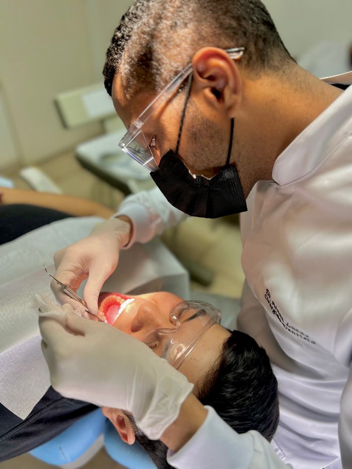 Dentist examining a patient's teeth in a clinic setting with professional care.