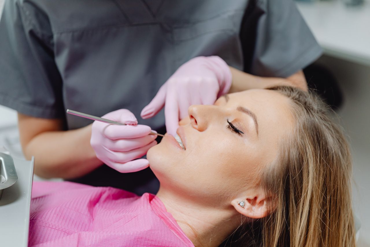 Crafting Captivating Headlines: Your awesome post title goes here A female patient receives a dental examination by a dentist in a clinic.